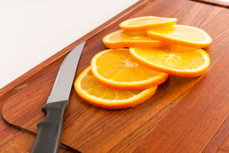 sliced oranges on cutting board. Isolated on white background