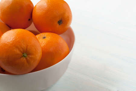 oranges on a yellow dish. Wooden backgroundの写真素材