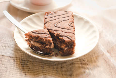 cake on a white plate standing on the wooden background