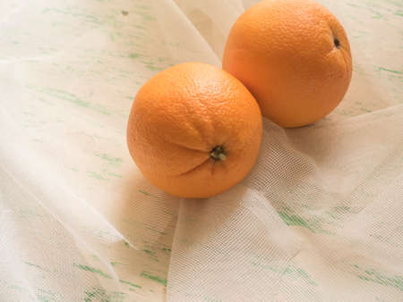 fresh oranges on rough fabric background