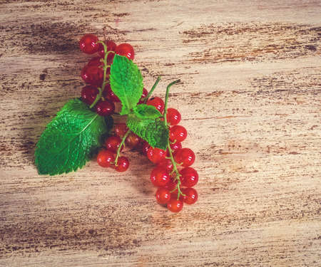 Red currant is on wooden backgroundの写真素材
