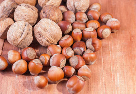 Mix of nuts on wooden background.