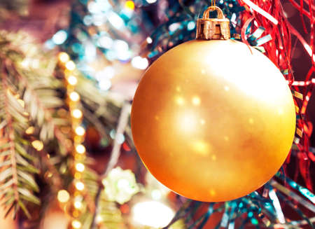 Hanging on branch Christmas balls on the background of Christmas tinsel.の写真素材