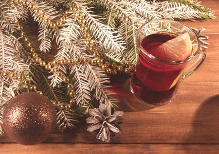 Christmas mulled wine with fir tree and decor on wooden tableの写真素材
