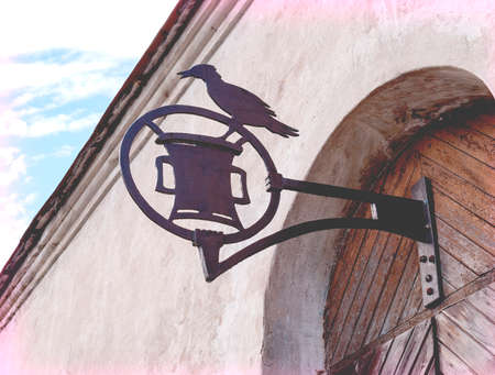 vintage wrought iron advertising sign with the bird on the bracketの写真素材