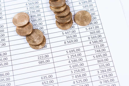 Coins lie on the sales charts. Business backgroundの写真素材