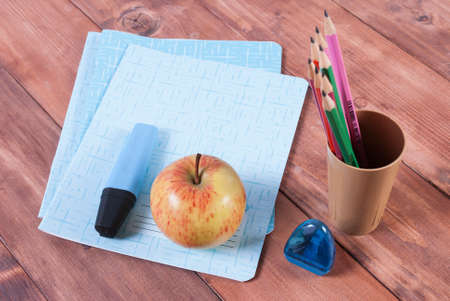 Marker, notebooks, pencils and sharpener. Stationery set for school on the tableの写真素材