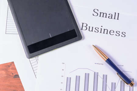 Tablet and pen on financial charts