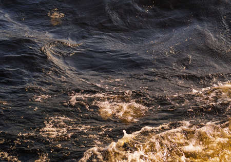 The reflection of evening sunlight on a wave.の写真素材