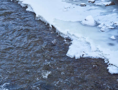 Ice and snow in the creekの写真素材