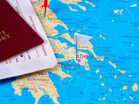 Passport with airline tickets and a map with marked route