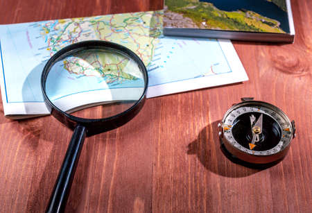 Tabletop surface with map, magnifier and compass