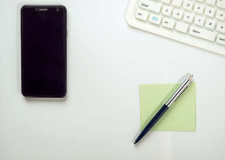 Smartphone, notebook and ballpoint pen on white backgroundの写真素材