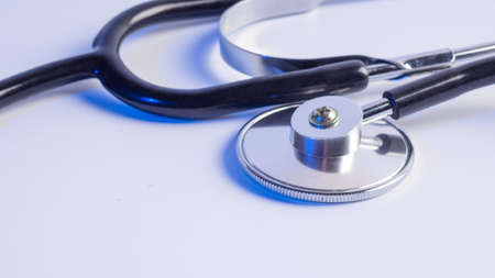 Medical stethoscope on a blue background.
