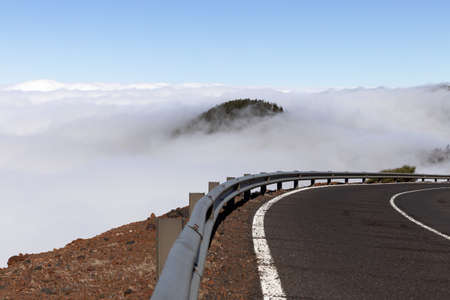 Winding mountain road above the clouds on the island of Tenerifeの写真素材