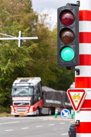 Truck passing a road intersection at a green light of a traffic signalの写真素材