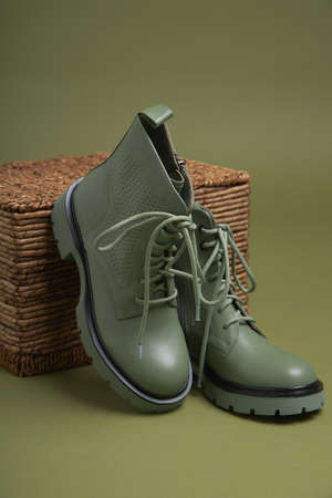 Fashion female green shoes on green background. Fashion shoes made of eco-leather autumn-winter 2022.の写真素材