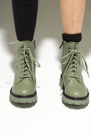 Female fashionable winter boots on white backgroundの写真素材