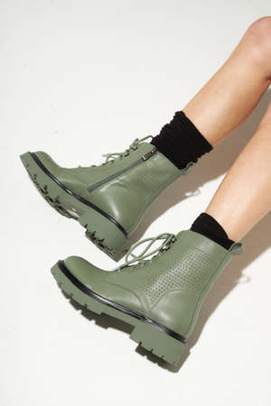 New fashion collection of footwear autumn winter on the feet of models. Boots in the style of a military on a white background. Fashion photos of shoes. Winter bootの写真素材