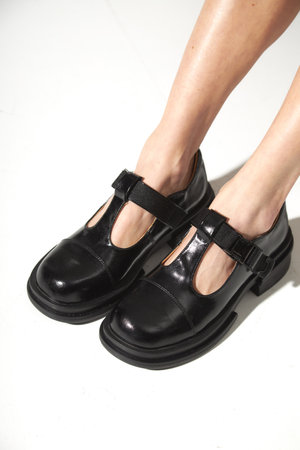 Beautiful woman legs in black shoes. Studio shot on white backgroundの写真素材