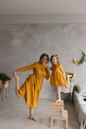 Close up of happy young mother hug cuddle with cute small preschooler daughter talk sharing secret, smiling mom embrace little girl child show love and care, enjoy sweet tender moment togetherの写真素材