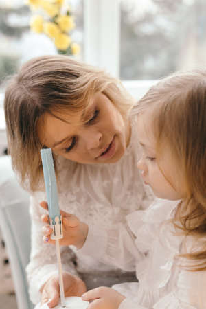 Mother and daughter enjoy at home and looking at cameraの写真素材