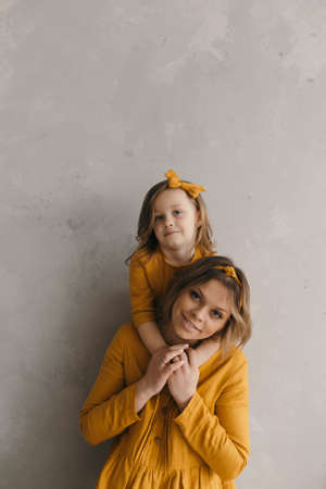 mom kisses daughter in the sunset backlightの写真素材