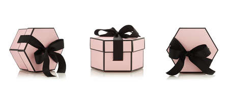 Pink pastel empty gift box with black ribbon isolated on white backgroundの写真素材
