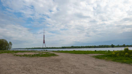 Riga Radio and TV Tower near Daugava river with green trees.の写真素材