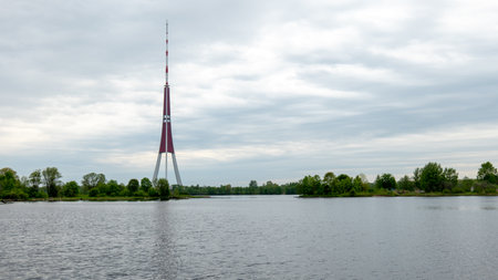 Riga Radio and TV Tower near Daugava river with green trees.の写真素材