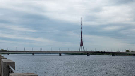 Riga Radio and TV Tower near Daugava river with green trees.の写真素材
