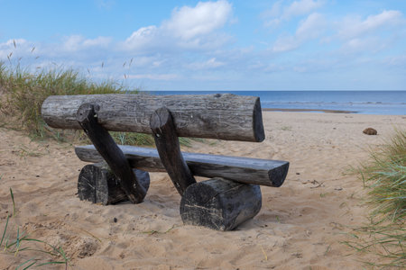 Wooden bench on the beach of the Baltic Sea in Poland.の写真素材