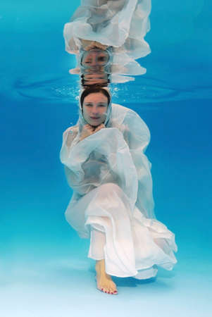 Bride underwater for wedding in a poolの写真素材