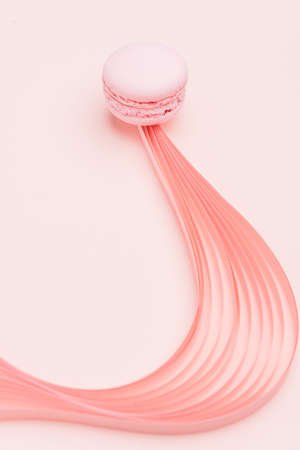 Pink Macaron and paper strips on a light backgroundの写真素材