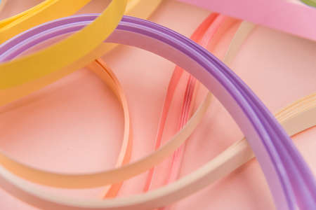 Rainbow colored filigree paper laid out in waves and shapes