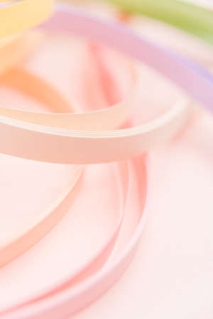 Rainbow colored filigree paper laid out in waves and shapesの写真素材