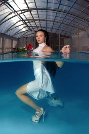Bride in a wedding  with flowers underwater in the pool. Underwater wedding の写真素材