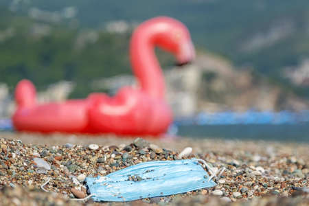 BECICI ANDi BUDVA, BUDVA MUNICIPALITY, MONTENEGRO - JULY 31, 2020: Discarded used face mask lies on...