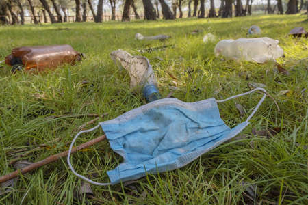 Face mask, plastic and other garbage thrown by tourists pollutes parks. Plastic garbage environmental pollution problem. Kartal Eco Park, Odessa oblast, Ukraine, Eastern Europeの写真素材
