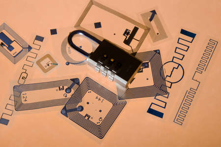 Cipher lock on RFID tags, orange backgroundの写真素材