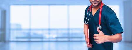 medical advertisement design. medicine, people and health care concept - close up of asian male doctor thumbs up with stethoscope over blue background. promotional bannerの写真素材