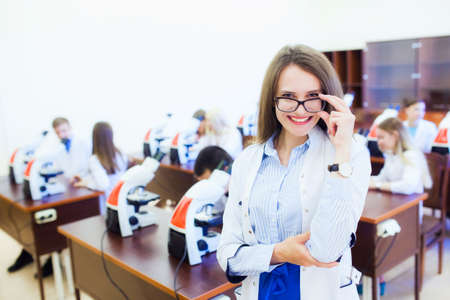 healthcare and health. Attractive female doctor in front of medical groupの写真素材