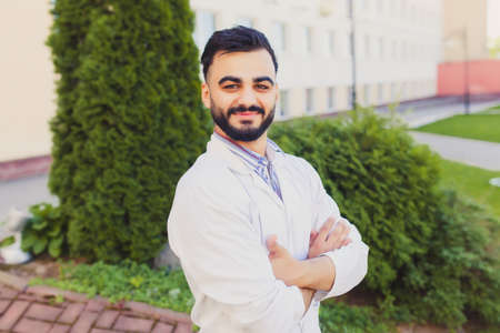 Closeup portrait of friendly, smiling confident male doctor, healthcare professional with stethoscope around neck, arms crossed. Patient visit. Health care reform.の写真素材
