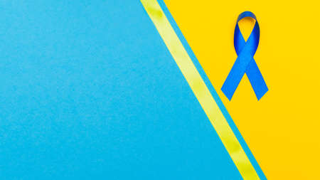 Dark blue ribbon awareness for aids day concept. yellow-blue backgroundの写真素材
