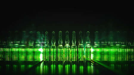 concept of development of the production of medical products. Bright vials with luminous green contents: Poisons, doping, Acid, chemistry, antibiotics, Sedatives, Narcotic drugs.  low key photoの写真素材