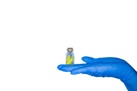 holding pill capsule drugs in hand latex glove white background. medicine for various diseases hospital concept. isolatedの写真素材