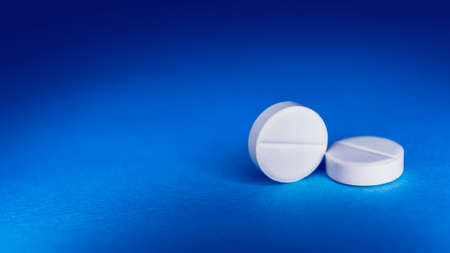 White tablet on a blue background. medicine preparationsの写真素材