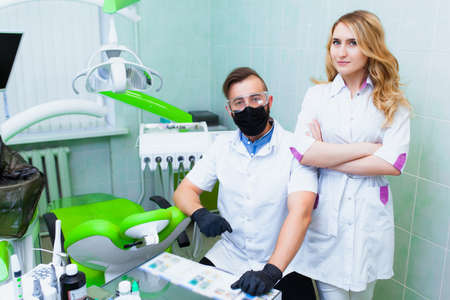 Staff professional doctor dentist in a modern office with dental equipment. The concept of health insurance and free dental care. Prosthetics and installation of veneers.の写真素材