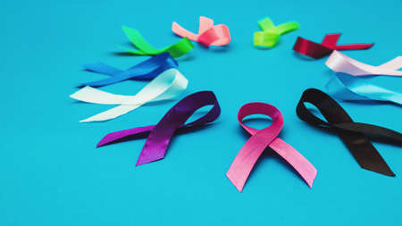 World cancer day February 4 background. Colorful ribbons, cancer awareness. blue surface from above.