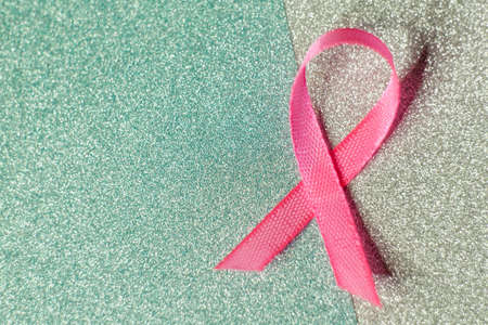 Pink ribbon for breast cancer awareness, symbolic bow color raising awareness on people living with...